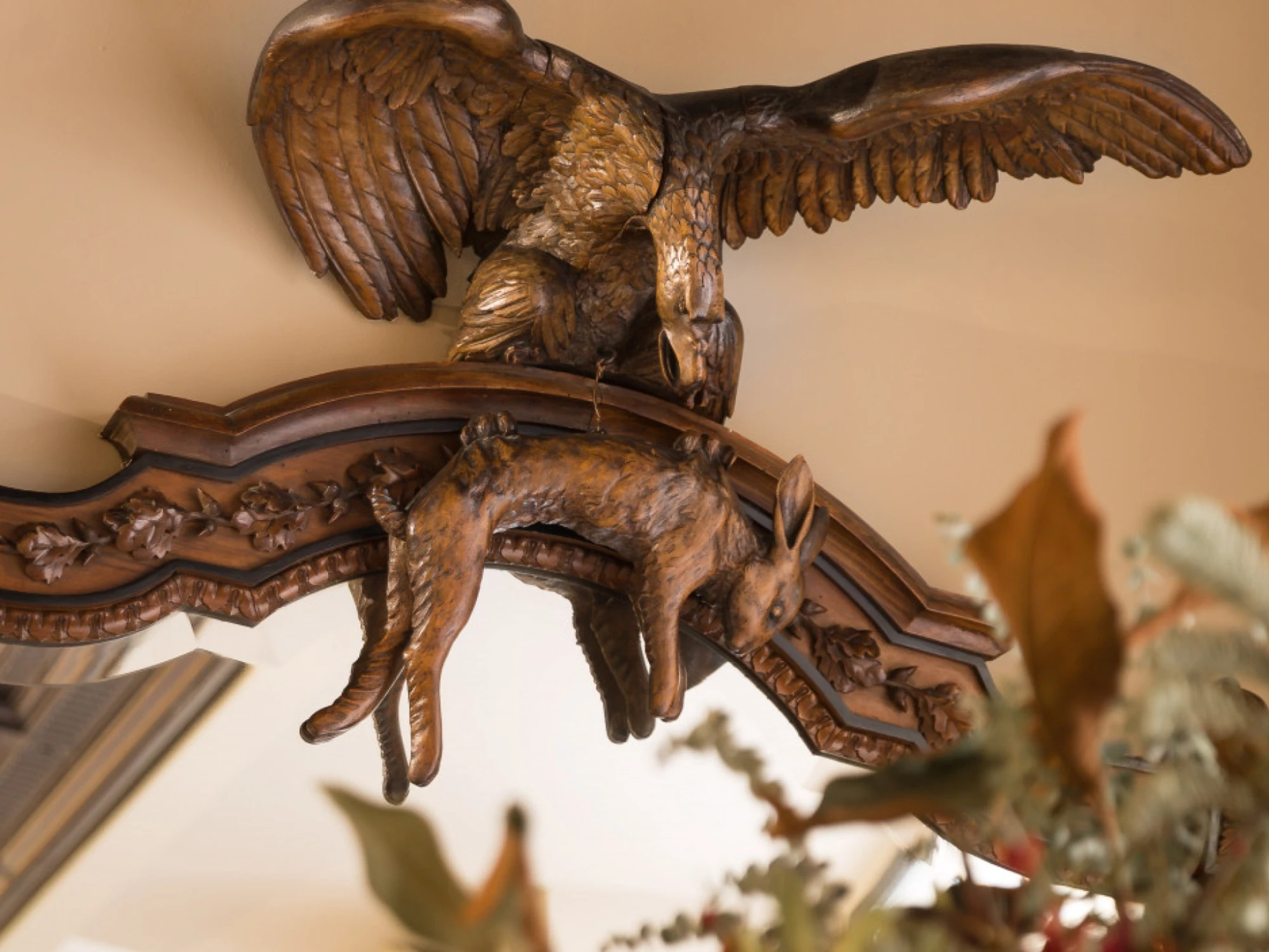 Se ve una estatua de águila tallada sobre una estructura decorativa de madera.