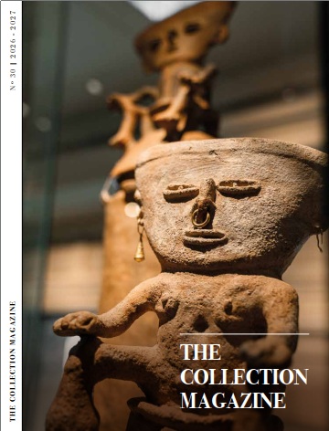 Se ve el lomo de una figura decorativa y el texto “THE COLLECTION MAGAZINE” sobre fondo desenfocado.